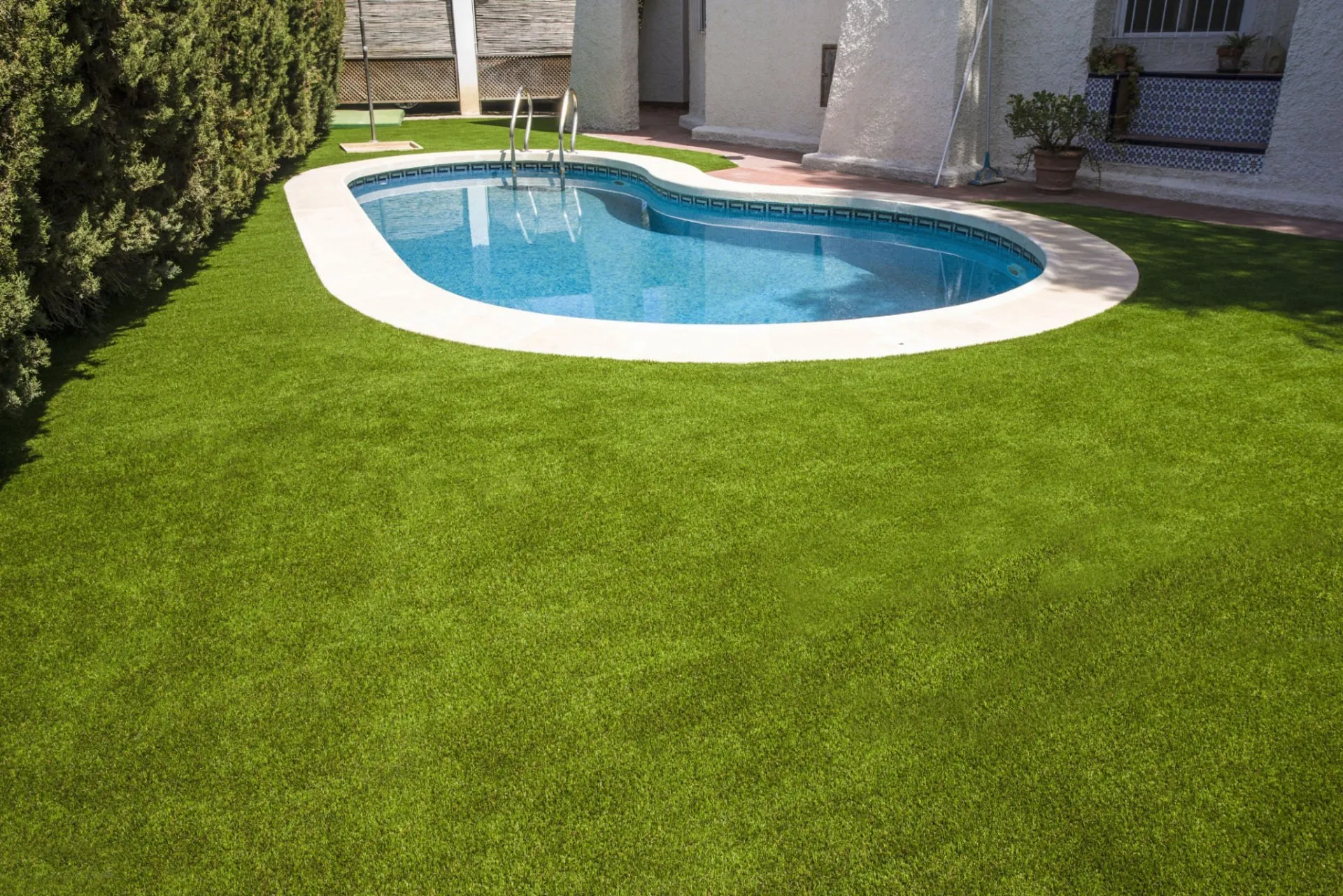 Synthetic turf system installed around a pool in a property in Scottsdale AZ